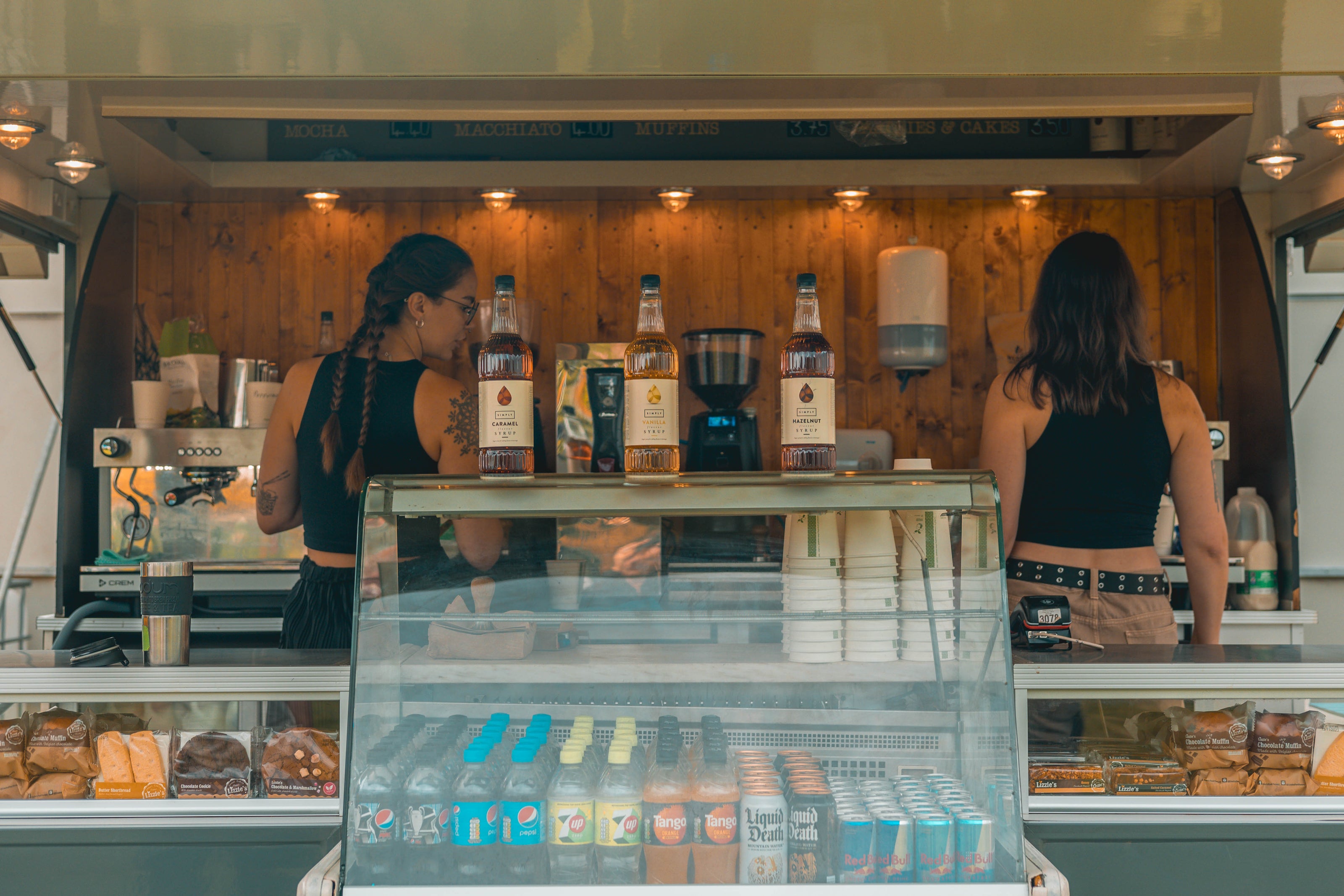 Two baristas in mobile coffee trailer